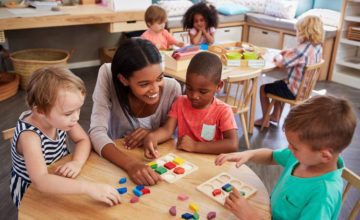 Child care professionals with toddlers playing